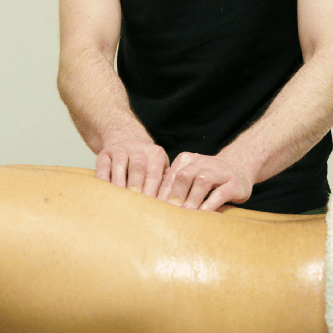 image shows massage therapist performing massage on back