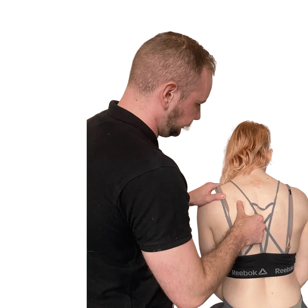 sports therapist performing injury assessment and tests on back muscles for pain